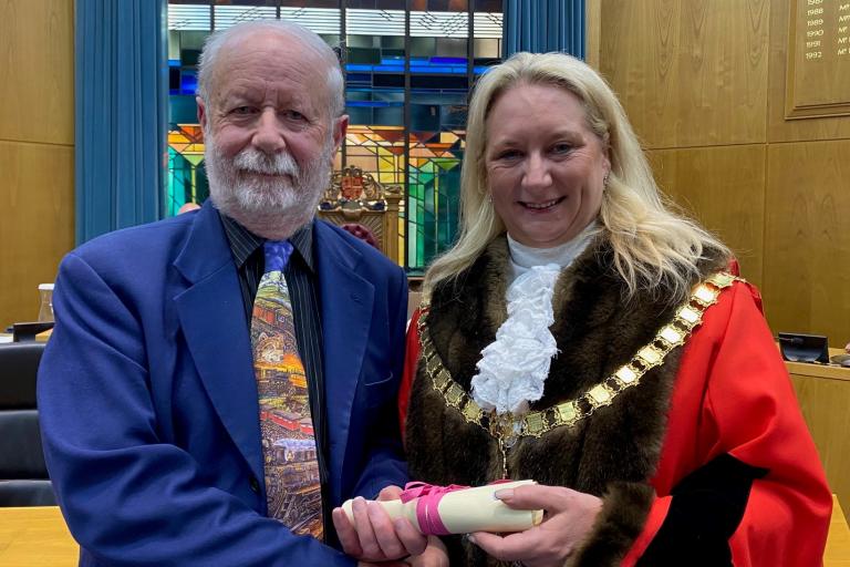 Jim Allen receives his Eminent Citizen award from Mayor of Woking, Cllr Amanda Boote, in the Council Chamber