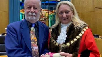 Jim Allen receives his Eminent Citizen award from Mayor of Woking, Cllr Amanda Boote, in the Council Chamber